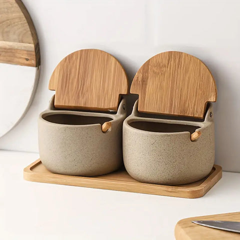 Dual ceramic spice jars on wooden tray with bamboo lids