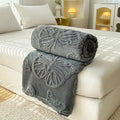 Charcoal gray butterfly throw blanket on bed – modern cozy fleece blanket