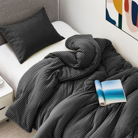 Charcoal Grey Waffle Quilt with Matching Pillow on Modern Dorm Bed – Soft, Warm, and Stylish Bedding