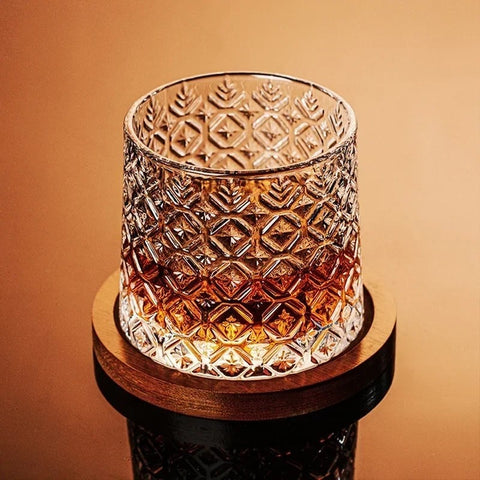 Close-up of geometric crystal tumbler on coaster