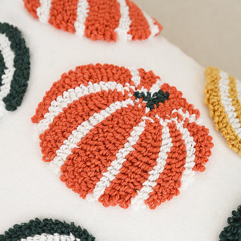 Close-up detail of tufted pumpkin cushion cover and throw pillow for Halloween decor