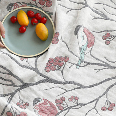  Close-up of bird and berry woven cotton fabric with fruits beside