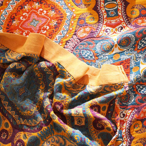 Close-up of orange and blue bohemian quilt showing fabric fold