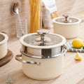 Close-up of beige steamer pot with glass lid and pasta in background