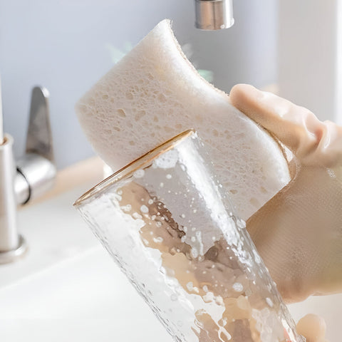 Lathering dishes with absorbent eco cleaning sponge