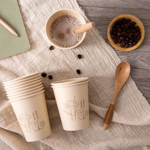 Cups with bamboo design placed beside spoon
