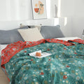 Cozy Coral Reef Boho Cotton Throw Blanket spread neatly on a bed with white and gray pillows