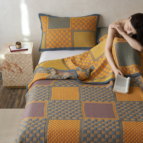 Cotton gauze quilt with orange and navy checkerboard pattern