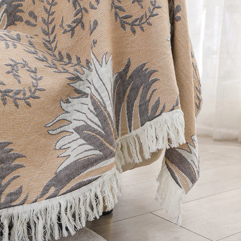 Close-up of tassel trim on reversible cotton jacquard couch throw blanket