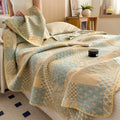 Lightweight cotton quilt with patchwork design draped over bed