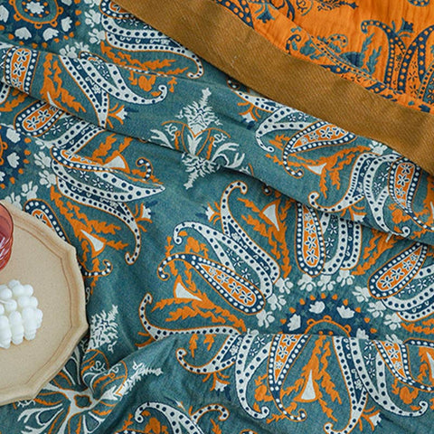 Close-up of textured cotton quilt edge with vibrant orange trim