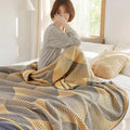 Woman covered in reversible cotton summer quilt