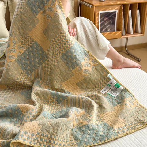 Cotton summer quilt with visible fabric label and shell stitch edge