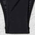 Close-up of bikini bottom with gold bead side ties – black stretch fabric