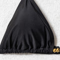 Close-up of black triangle bikini top with gold-tone beads and adjustable straps
