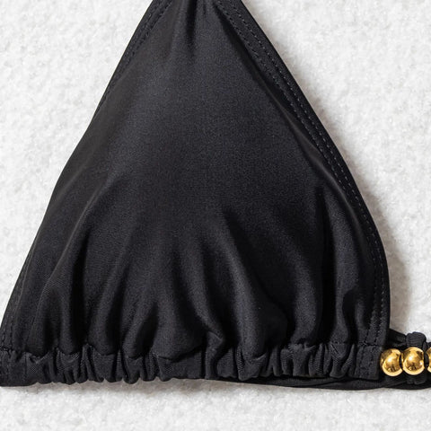 Close-up of black triangle bikini top with gold-tone beads and adjustable straps