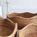 Curved edge rattan baskets styled for fruit and bread storage