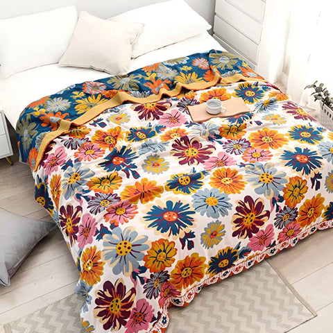 Top view of full spread Daisy Flower Cotton Blanket on a bed with cup of tea and tray