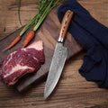Damascus chef knife on cutting board with raw meat