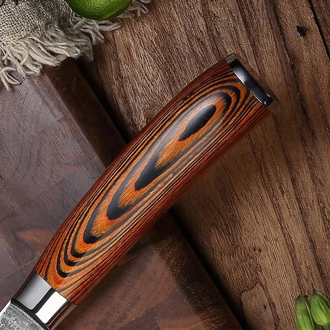 Wooden-handled knife on a wooden surface with a lime in the background