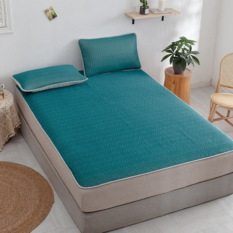 Dark green Thai latex cooling mat with matching pillows in cozy room