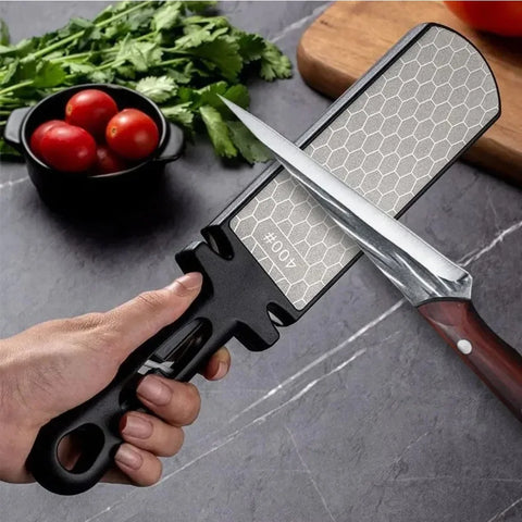 Black diamond knife sharpener used to sharpen kitchen knife on countertop