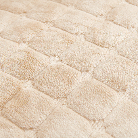 Close-up of a textured beige fabric with a diamond pattern of sofa chair recliner cover