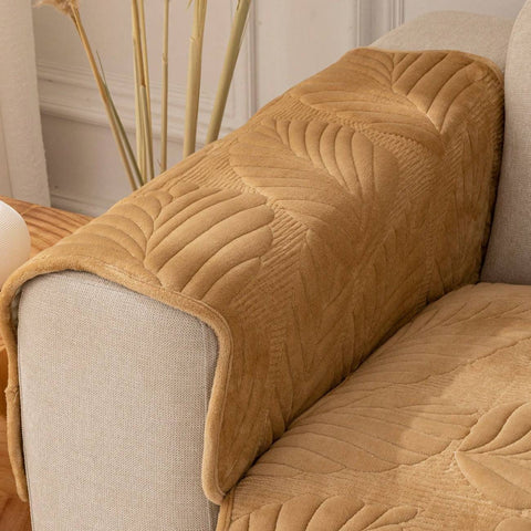 Detailed view of plush texture and leaf embroidery on armrest