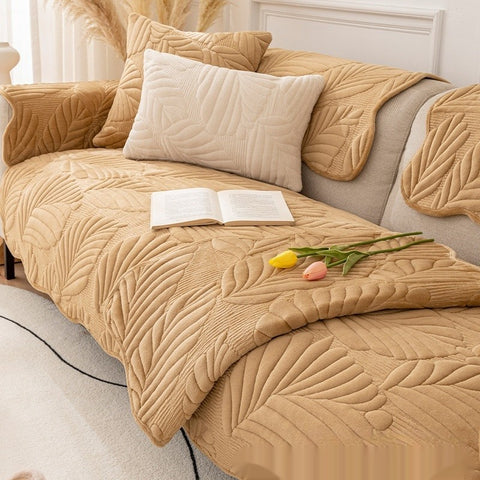 Camel plush sofa cover on 3-seater couch with decorative pillows
