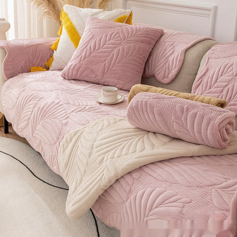 Lotus Pink quilted sofa cover with leaf design on cozy 3-seater