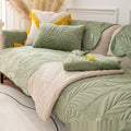 Matcha green plush non-slip sofa cover with pillows on modern couch