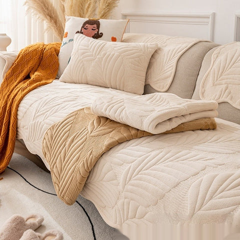 Milky white plush non-slip sofa cover with pillows on modern couch