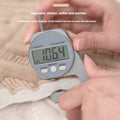 Digital caliper showing 10.64mm thickness of plush sofa cover for added warmth
