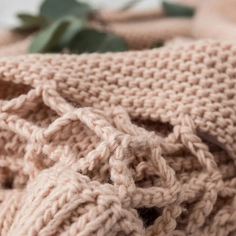 Detailed macro of Dusty Rose Handmade Knit Blanket tassel and weave pattern