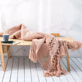 Dusty Rose Nordic Knit Tassel Blanket on bed – cozy luxury bedroom décor