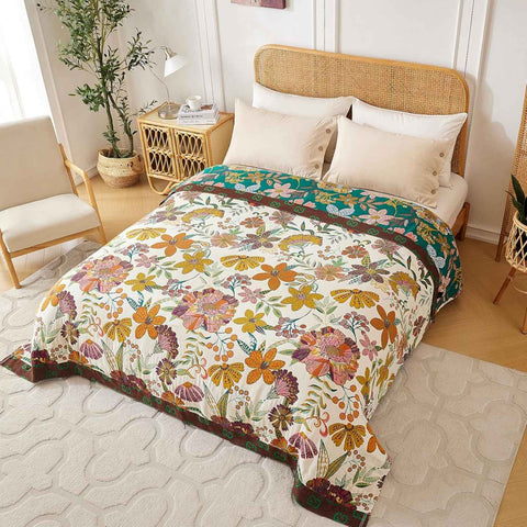 Bed with elegant cotton throw blanket comforter in a bright bedroom with beige pillows, natural rattan headboard