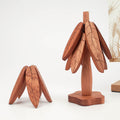 Folded wooden coasters shown with matching base