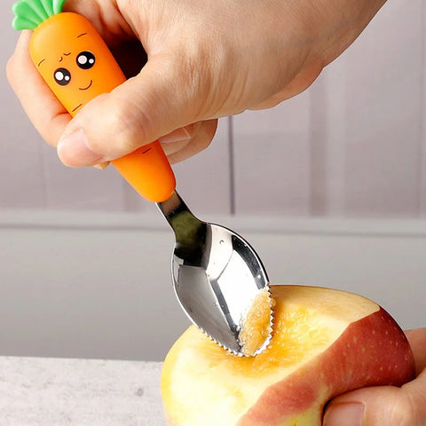 Toddler hand feeding apple using carrot kids spoon