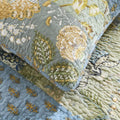 Cotton pillowcase detail showing hand-stitched floral patchwork design