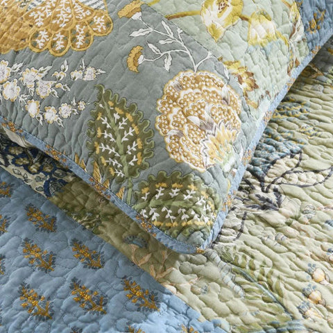 Cotton pillowcase detail showing hand-stitched floral patchwork design