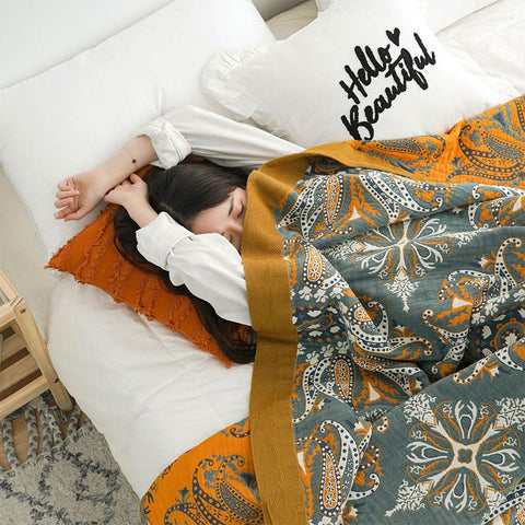 Lightweight floral quilt with mustard border used as a summer blanket
