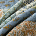 Close-up of floral embroidery and soft texture in cotton quilt