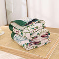 Folded floral-patterned quilt on a tatami mat floor
