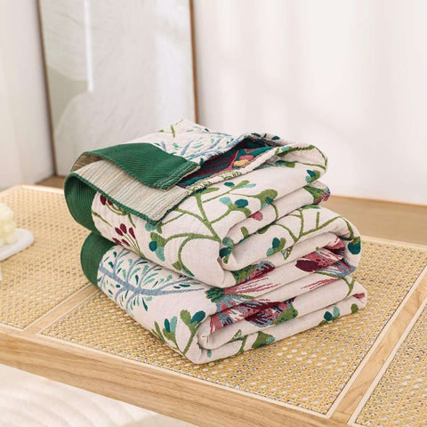Folded floral-patterned quilt on a tatami mat floor