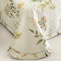 Lightweight quilt corner showing elegant floral stitching and drape