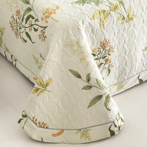 Lightweight quilt corner showing elegant floral stitching and drape