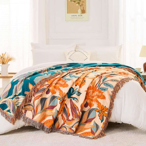 Floral patterned throw blanket on a bed in a bright bedroom