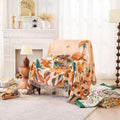 Floral-patterned blanket draped over a chair in a cozy living room.