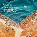 Floral-patterned fabric with teal top layer and colorful fringe, featuring text about fabric type.