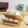 Foldable bamboo plate rack with dishes and cups